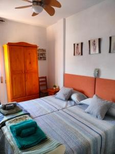 two beds sitting next to each other in a bedroom at Casa EL CASTILLO ,a 5 kilómetros de la playa in Mazarrón +28 photos