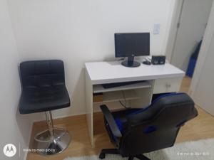 a desk with a computer monitor and a chair at Apartamento 88A in São Paulo