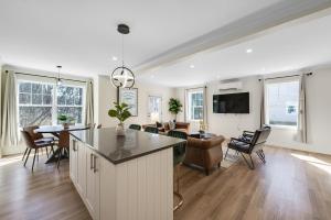 a kitchen and living room with a table and chairs at Amazing Entire Townhouse Sleeps 20 Group Favorite in Bloomfield