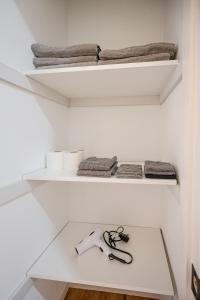 a pair of scissors sitting on a shelf in a closet at Amazing Entire Townhouse Sleeps 20 Group Favorite in Bloomfield