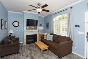 a living room with a couch and a fireplace at Sandbar Escape in Oceano