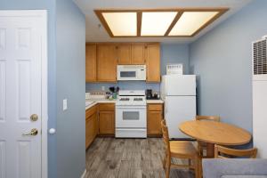 a kitchen with a white refrigerator and a table at Sandbar Escape in Oceano +7 photos