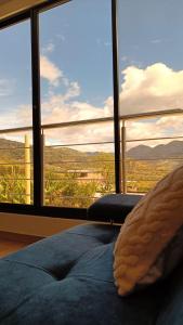 a bed in a room with a large window at Amaru 