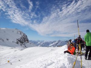 a group of people sitting on a snow covered mountain at Pensione Genzianella in Alagna Valsesia