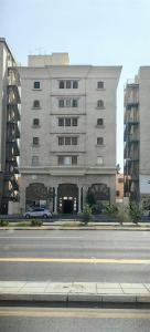a large building with a car parked in front of it at قمة قباءلشقق in Al Madinah