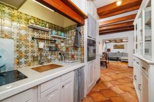 a kitchen with white cabinets and a tile wall at Holiday home in Selce 54425 in Selce +42 photos