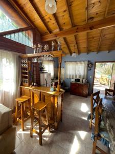 eine Küche mit einer Theke und Stühlen in einem Zimmer in der Unterkunft Alma del Bosque PILETA E HIDROMASAJES Semiclimatizados in Mar Azul