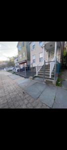 a fence in front of a house on a street at private room in Paterson
