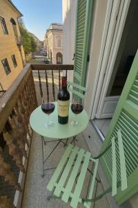 a table with a bottle of wine and two glasses at Casa PORTA LANERO di Francesco e Alessandro in Nizza Monferrato