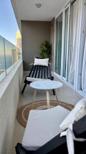 a balcony with two tables and a view of the ocean at Duna & Mar I Concon in Concón