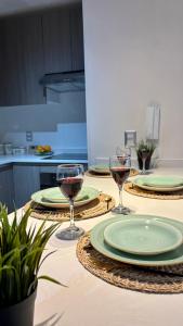 three glasses of wine on a table in a kitchen at Duna & Mar I Concon in Concón