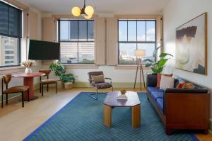 a living room with a couch and a table at The Barnett, part of JdV by Hyatt in New Orleans