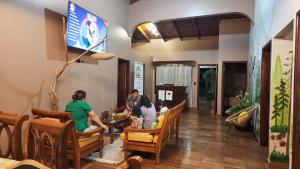 a group of people sitting at a table in a restaurant at Hostal Marias in Copán Ruinas