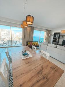 a dining room with a table and a living room at Panoramic Sea Views 3 Bedroom Apartment in St Julians in St Julian's