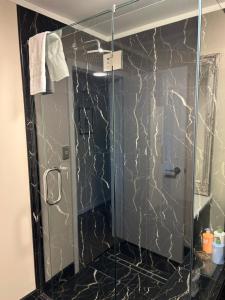 a shower with a glass door in a bathroom at Incredible mountain & sea views in Mapua +24 photos