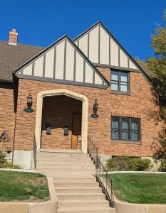 a brick house with stairs leading to the door at The Hillside - Historic Tudor retreat in SLC in Garden Towers Condominium
