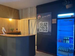 a room with a bar and a drink cooler at Casa Pirineus - Alojamiento rural & SKI RENT in Baro