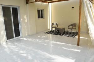 a living room with two chairs and a patio at Villa Acamar in Al Karnak