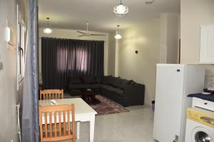 a living room with a couch and a table at Villa Acamar in Al Karnak