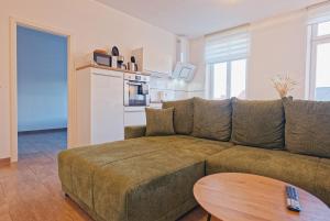 a living room with a couch and a table at Modern family apartment in Bamberg in Bamberg
