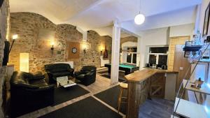a living room with couches and a pool table at Burgblick in Nossen