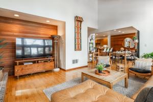 a living room with a couch and a tv at Cedar and Snow in Mammoth Lakes +37 photos