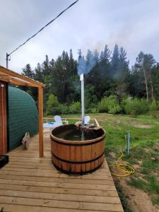 a hot tub sitting on a wooden deck at Espacio Verde in Juan Chico