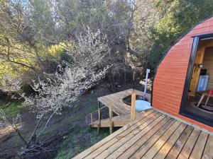 a wooden deck with a bench next to a house at Espacio Verde in Juan Chico