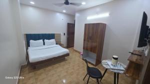 a bedroom with a bed and a table and a chair at fab THE MALEEN New Delhi in New Delhi