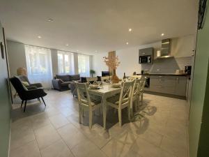 a kitchen and dining room with a table and chairs at Maison Lac de Chalain - Jura in Fontenu
