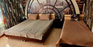 two beds in a room with a view of a city at Курортно студио in Sunny Beach +20 photos