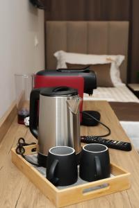 a coffee maker on a wooden tray with two cups at Hotel Castle View in Krujë +141 photos