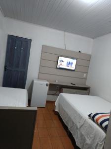 a room with two beds and a television in it at AP da val 3 no coração de Manaus in Manaus +8 photos