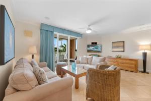 a living room with two couches and a table at Divi Village Condo 9 in Palm-Eagle Beach