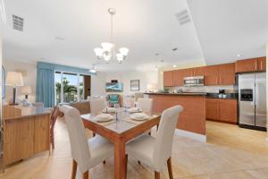a dining room and kitchen with a table and chairs at Divi Village Condo 9 in Palm-Eagle Beach