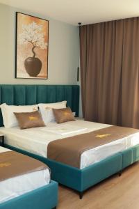 a bedroom with two beds and a painting on the wall at Hotel Castle View in Krujë