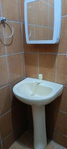 a white sink in a bathroom with a mirror at AP da val 3 no coração de Manaus in Manaus