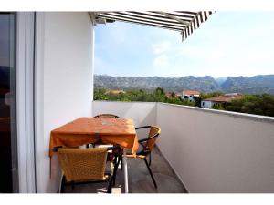 a table and chairs on a balcony with a view at Apartments in Starigrad-Paklenica 35542 in Seline