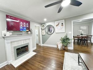a living room with a television and a fireplace at Stylish 2BR in Decatur - Big Deck - Pets OK - Fire Pit in Decatur