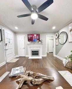 a living room with a ceiling fan and a fireplace at Stylish 2BR in Decatur - Big Deck - Pets OK - Fire Pit in Decatur