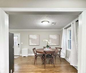 a dining room with a table and chairs at Stylish 2BR in Decatur - Big Deck - Pets OK - Fire Pit in Decatur +20 photos
