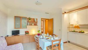 a kitchen with a table and a dining room at Apartment in Follonica - Toskana 44106 in Casa SantʼEugenia