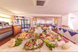 a long table with many plates of food on it at Apartment in Follonica - Toskana 44106 in Casa SantʼEugenia