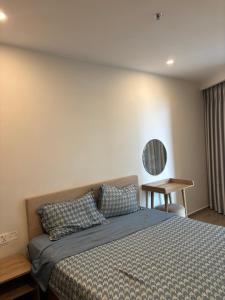 a bedroom with a bed and a table in it at The Sóng Homestay Vibes by the Sea in Vung Tau