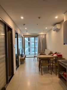 a kitchen and living room with a table and chairs at The Sóng Homestay Vibes by the Sea in Vung Tau +13 photos