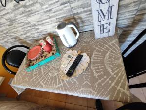 einen Tisch mit einem Teller mit Lebensmitteln und einer Fernbedienung in der Unterkunft ACOL Habitaciones individuales in Perito Moreno