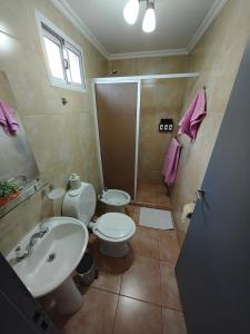 ein Badezimmer mit Toilette, Waschbecken und Dusche in der Unterkunft ACOL Habitaciones individuales in Perito Moreno + 10 Fotos