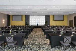 a conference room with tables and chairs and screens at Renaissance Daytona Beach Oceanfront Hotel in Daytona Beach +95 photos