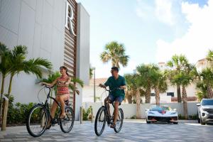 a man and a woman riding bikes down a street at Renaissance Daytona Beach Oceanfront Hotel in Daytona Beach