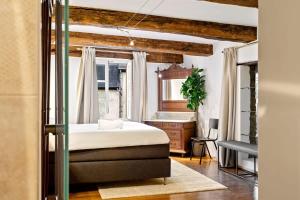 a bedroom with a bed and a desk and a window at Charming Grund Retreat Near Neumünster Abbey in Luxembourg